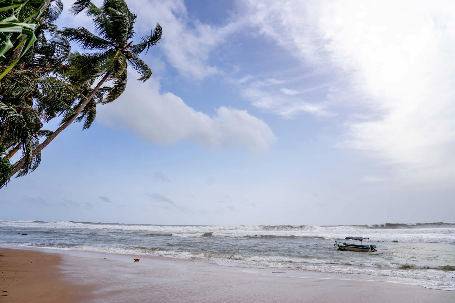 Golden beach at sunset in Bentota Sri Lanka with calm ocean waters